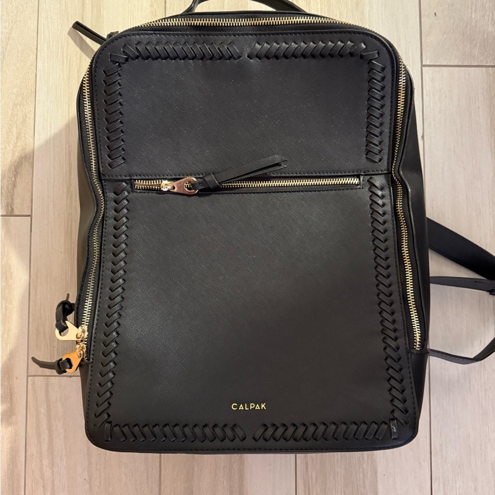 Calpak Black Backpack with Sleek Design and Gold Accents